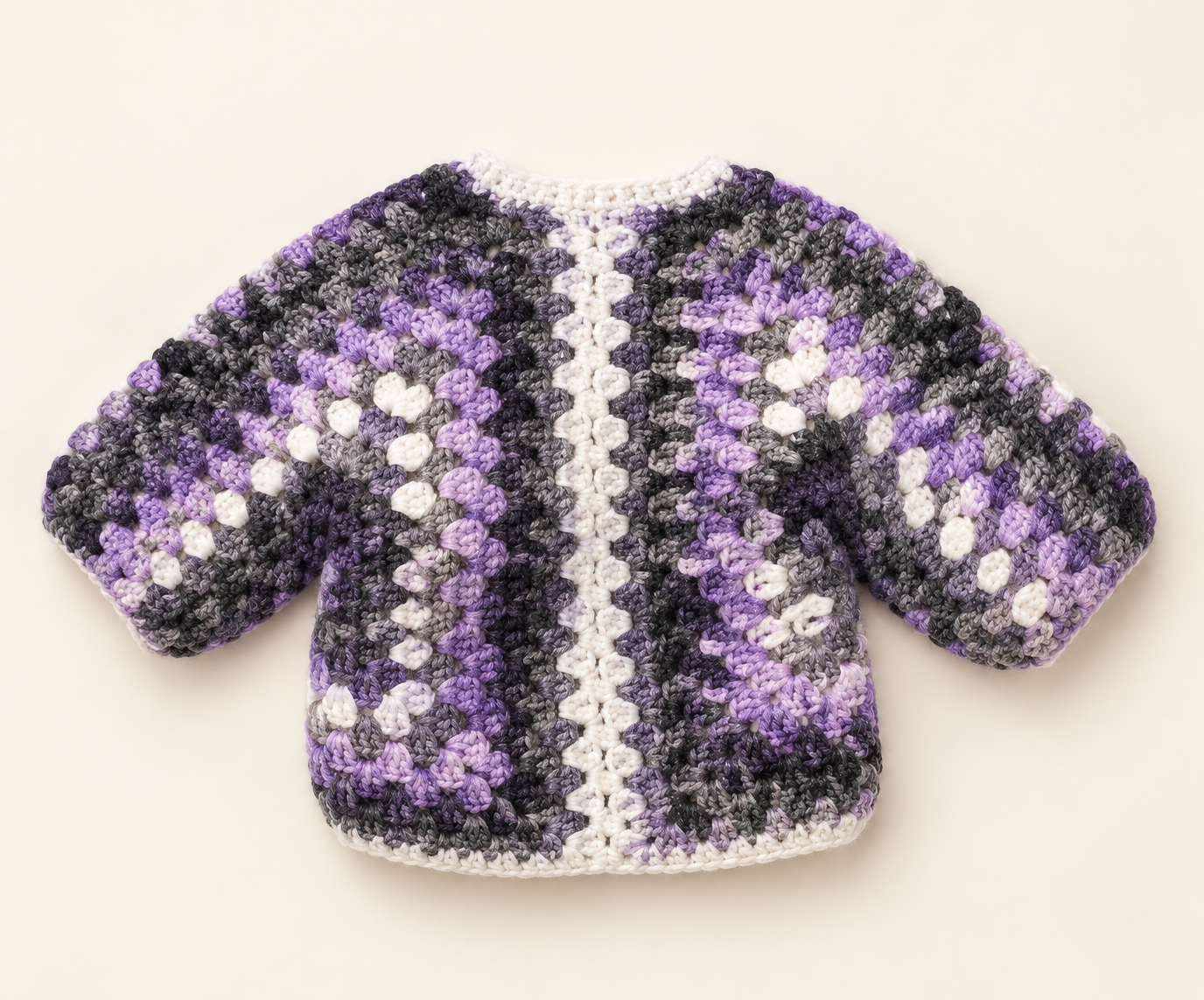 Styled preview of a purple, black, and white crochet cardigan